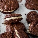 Chocolate brownie cookie sandwiches with peanut butter frosting filling